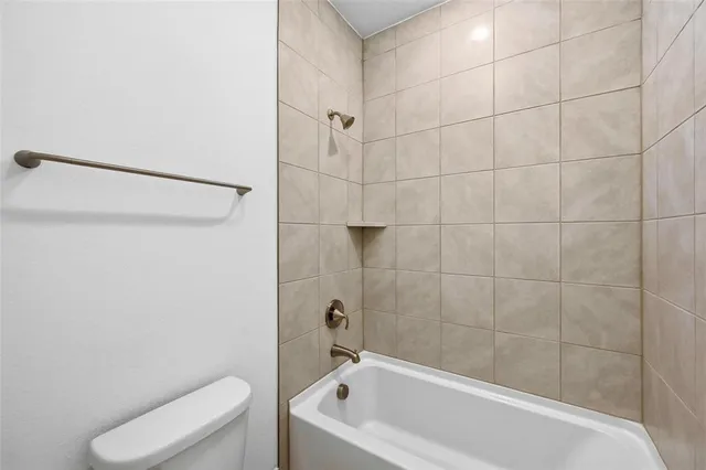 a bathroom with a bathtub and toilet