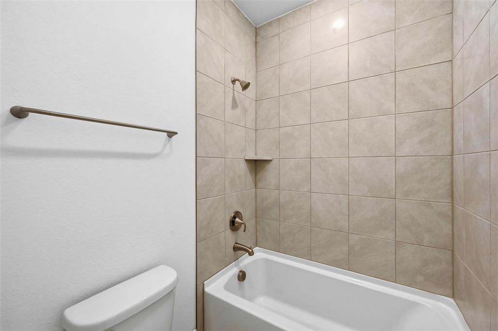 4365 Knight Street Midlothian, TX 76065 - Photo 24 of 33 a bathroom with a bathtub and toilet
