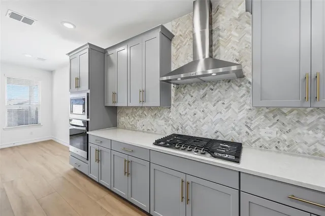 a kitchen with stainless steel appliances granite countertop a stove and a refrigerator