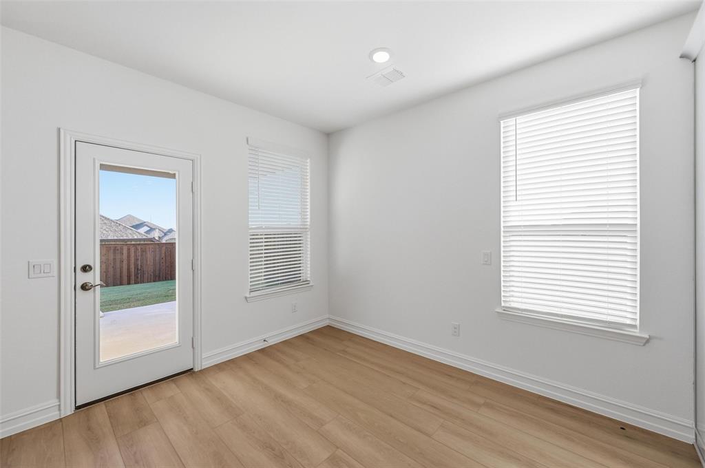 4365 Knight Street Midlothian, TX 76065 - Photo 6 of 33 an empty room with wooden floor and windows