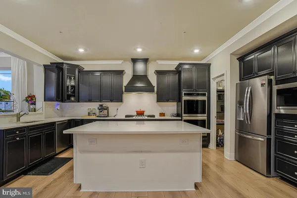 a kitchen with stainless steel appliances a sink stove and refrigerator