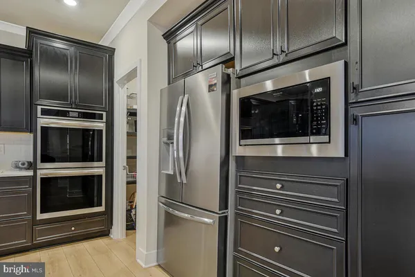 a kitchen with stainless steel appliances granite countertop a sink and stove