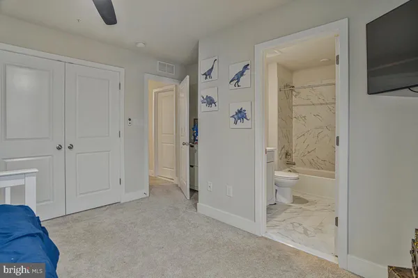 an empty room with a window and a ceiling fan