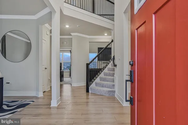 a view of a hallway with wooden floor and entryway