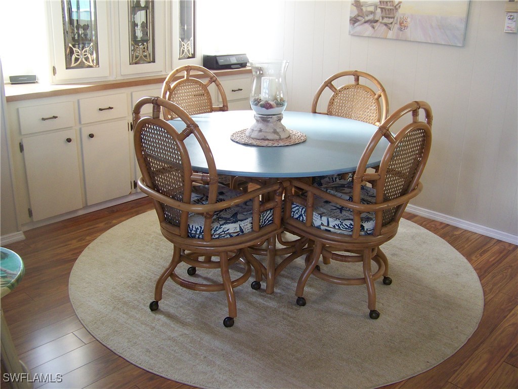 15550 Burnt Store Road, Unit 63 Punta Gorda, FL 33955 - Photo 13 of 47 a dining room with furniture and wooden floor