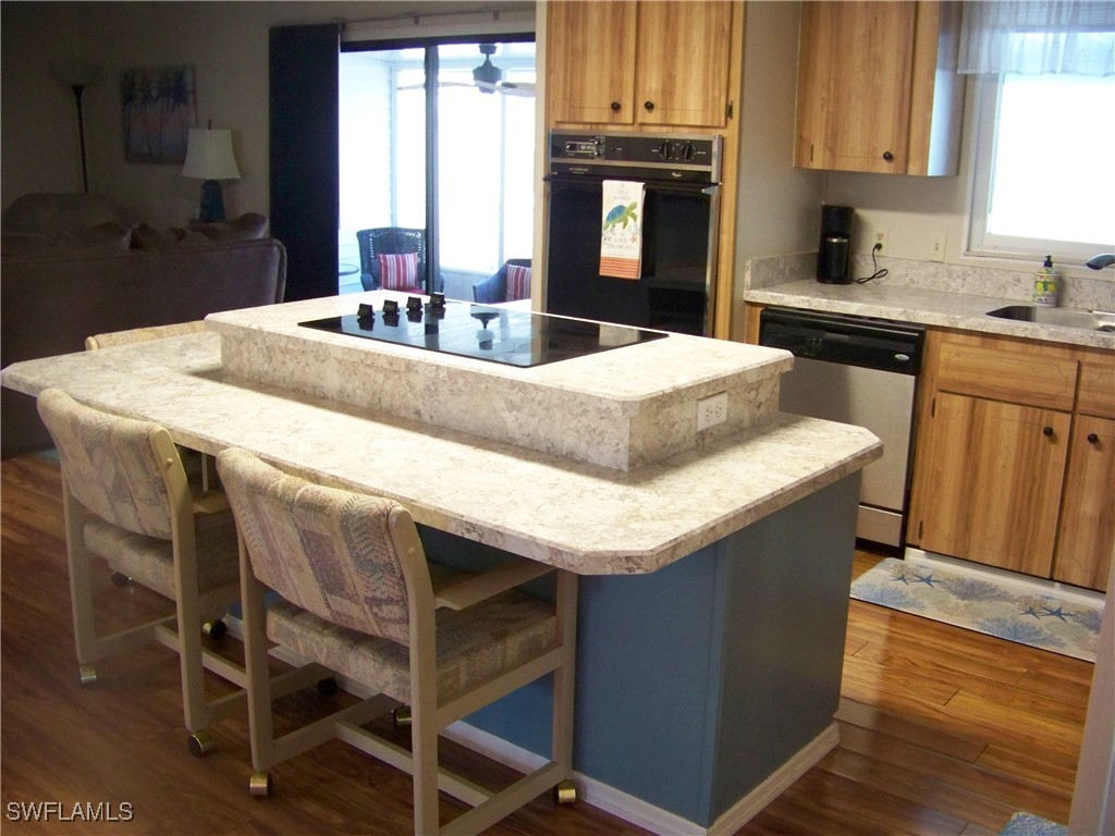 15550 Burnt Store Road, Unit 63 Punta Gorda, FL 33955 - Photo 15 of 47 a kitchen with granite countertop a sink cabinets and window