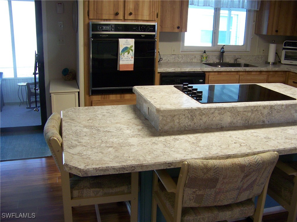 15550 Burnt Store Road, Unit 63 Punta Gorda, FL 33955 - Photo 18 of 47 a dining table with chairs and wooden floor