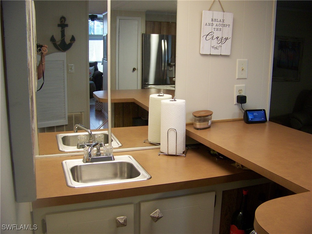 15550 Burnt Store Road, Unit 63 Punta Gorda, FL 33955 - Photo 21 of 47 a bathroom with a sink and a mirror