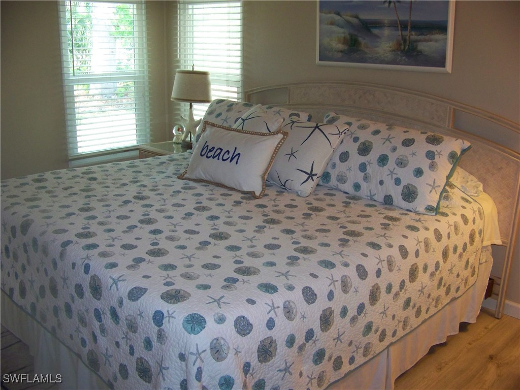 15550 Burnt Store Road, Unit 63 Punta Gorda, FL 33955 - Photo 25 of 47 a bed sitting in a bedroom next to a window