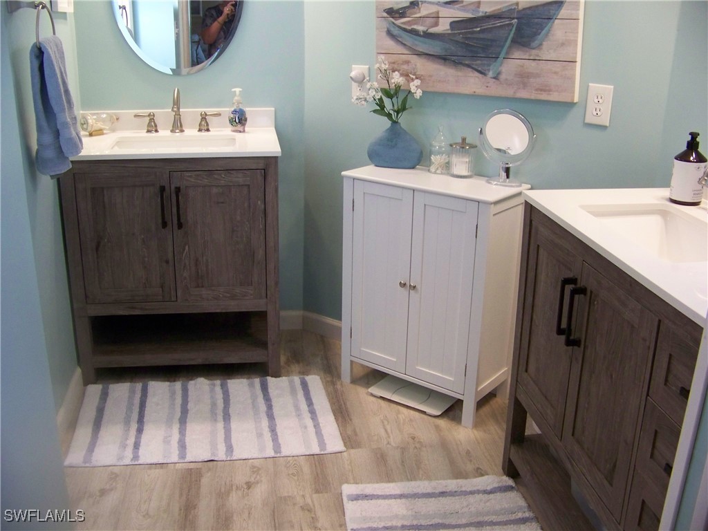 15550 Burnt Store Road, Unit 63 Punta Gorda, FL 33955 - Photo 28 of 47 a bathroom with a sink a mirror and vanity