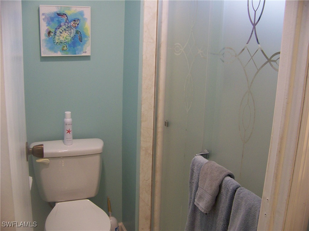 15550 Burnt Store Road, Unit 63 Punta Gorda, FL 33955 - Photo 30 of 47 a white toilet sitting next to a bathroom sink