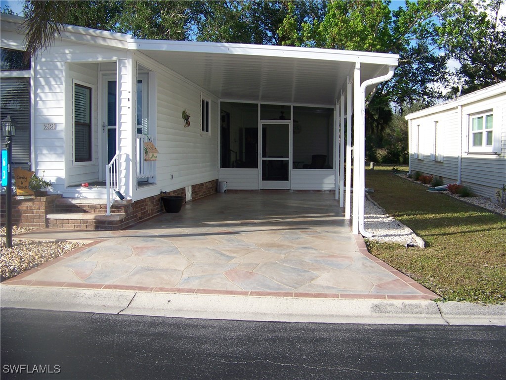 15550 Burnt Store Road, Unit 63 Punta Gorda, FL 33955 - Photo 3 of 47 a view of a house with a yard