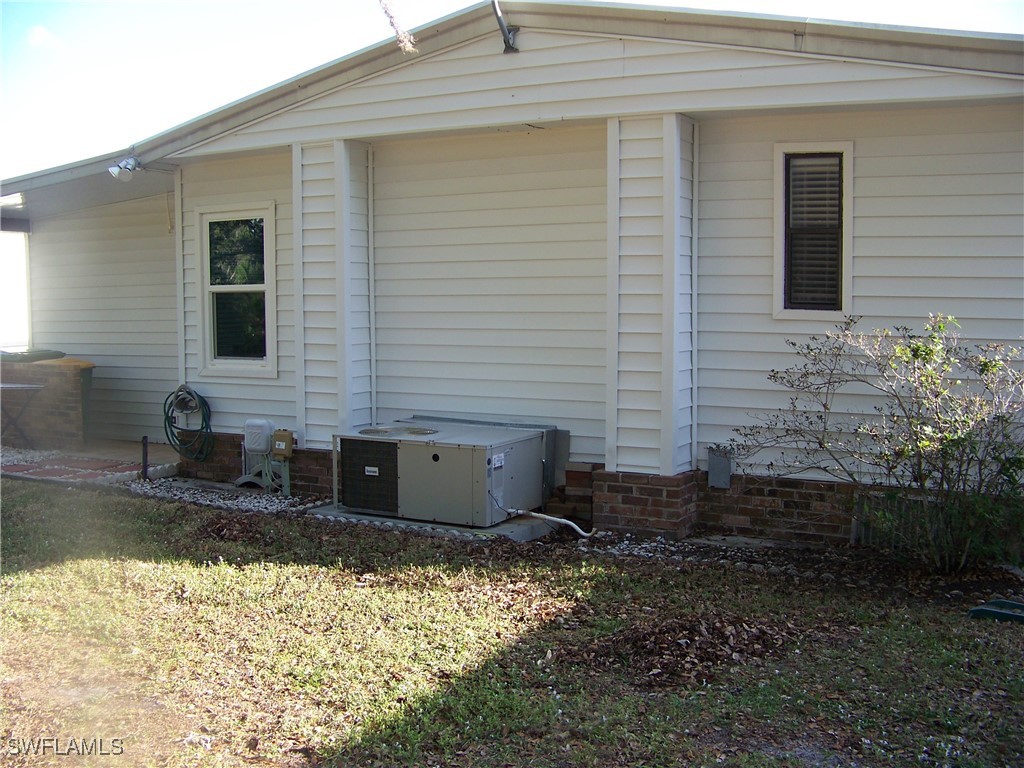 15550 Burnt Store Road, Unit 63 Punta Gorda, FL 33955 - Photo 5 of 47 a view of a backyard with plants and large tree