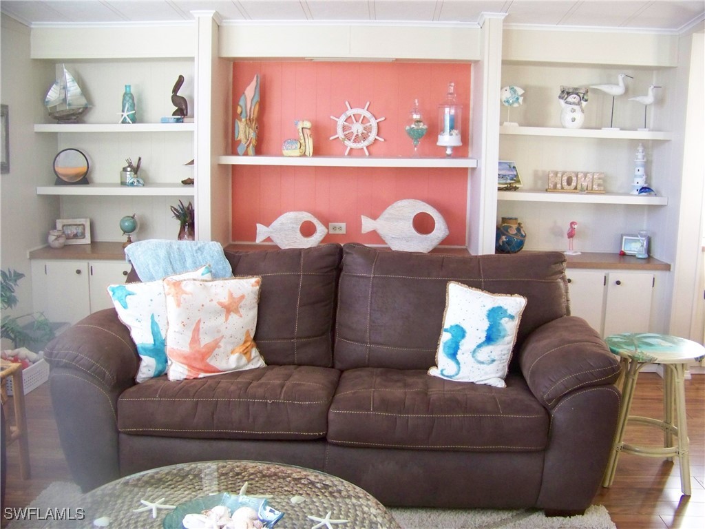 15550 Burnt Store Road, Unit 63 Punta Gorda, FL 33955 - Photo 8 of 47 a living room with furniture and a shelf