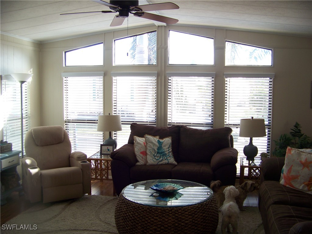 15550 Burnt Store Road, Unit 63 Punta Gorda, FL 33955 - Photo 10 of 47 a living room with furniture and a large window
