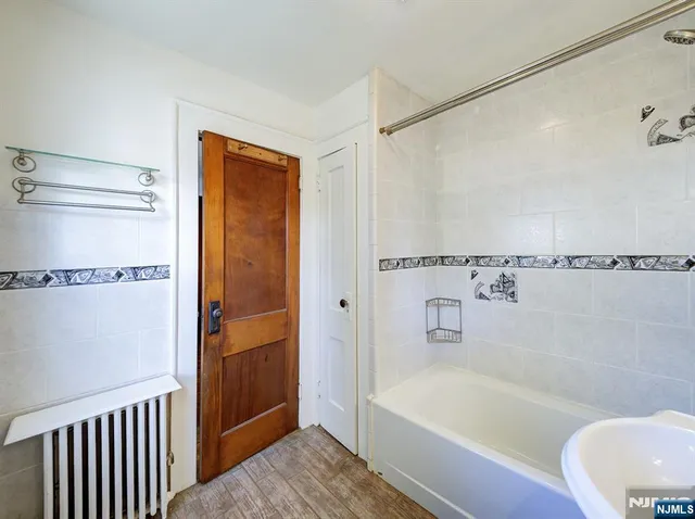 a bathroom with a bathtub a toilet and a shower