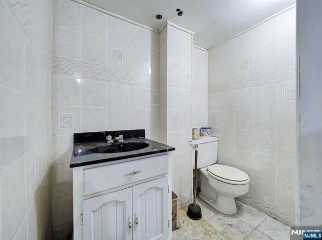 a bathroom with a sink a toilet and a mirror