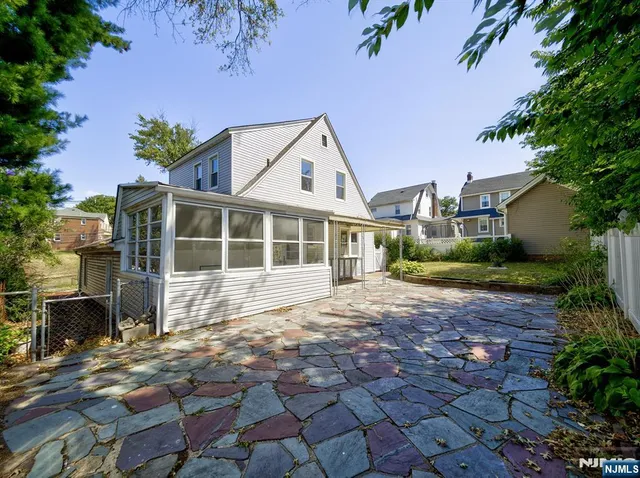 a view of a house with a yard and potted plants