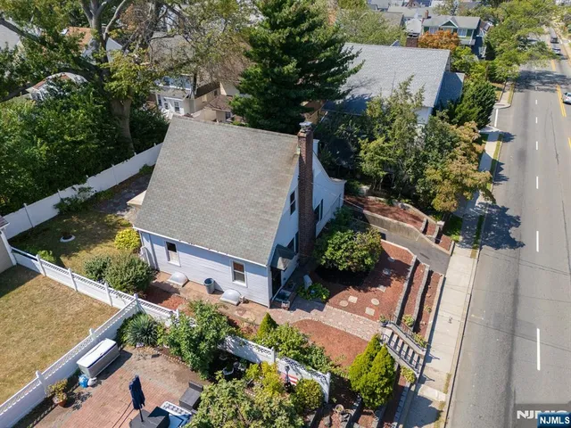 an aerial view of a house with a yard and outdoor seating