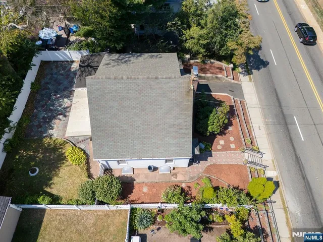 an aerial view of a house with a yard and a fountain