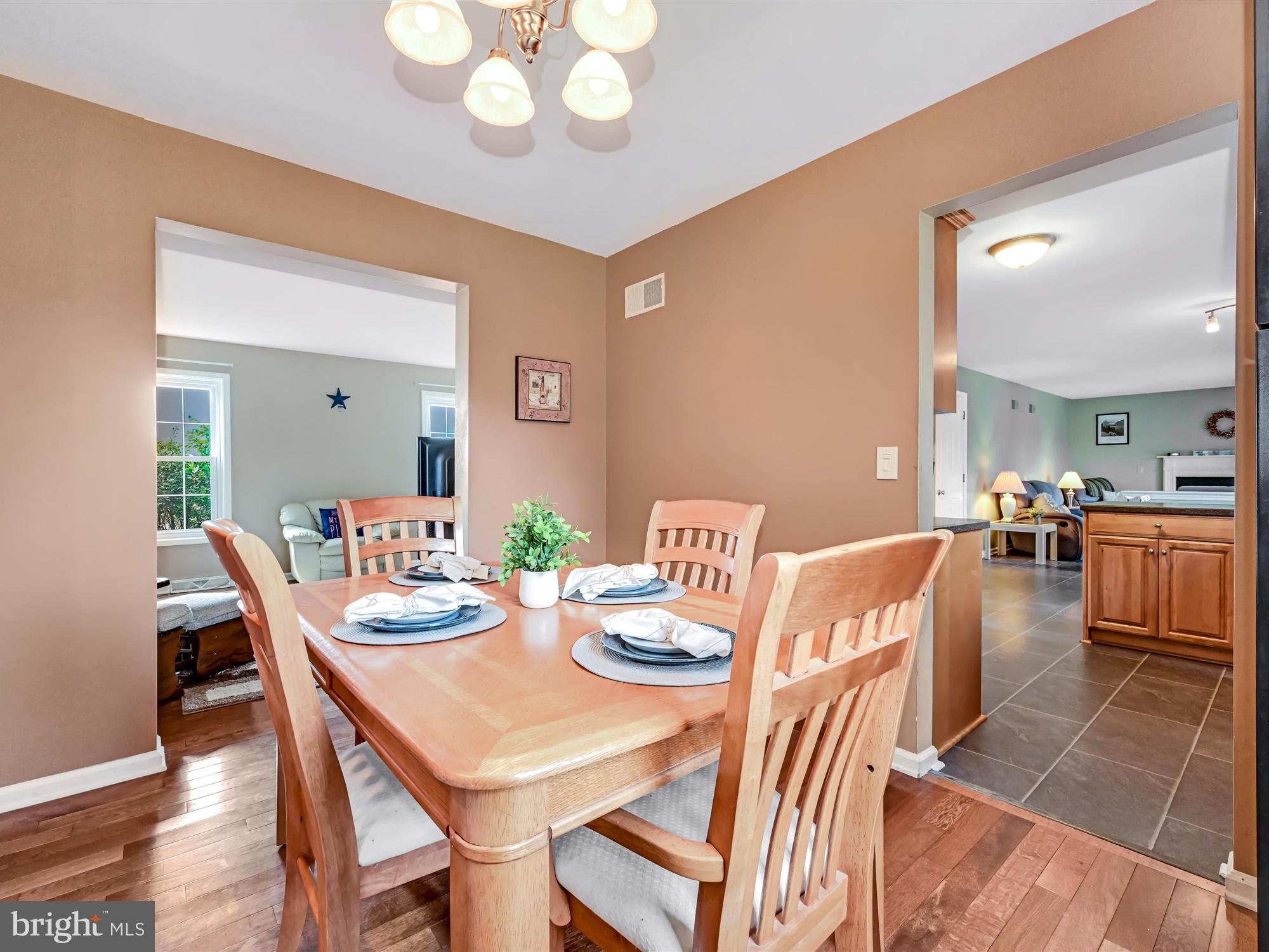 205 Village Spring Lane Reinholds, PA 17569 - Photo 8 of 29 a view of a dining room with furniture and wooden floor