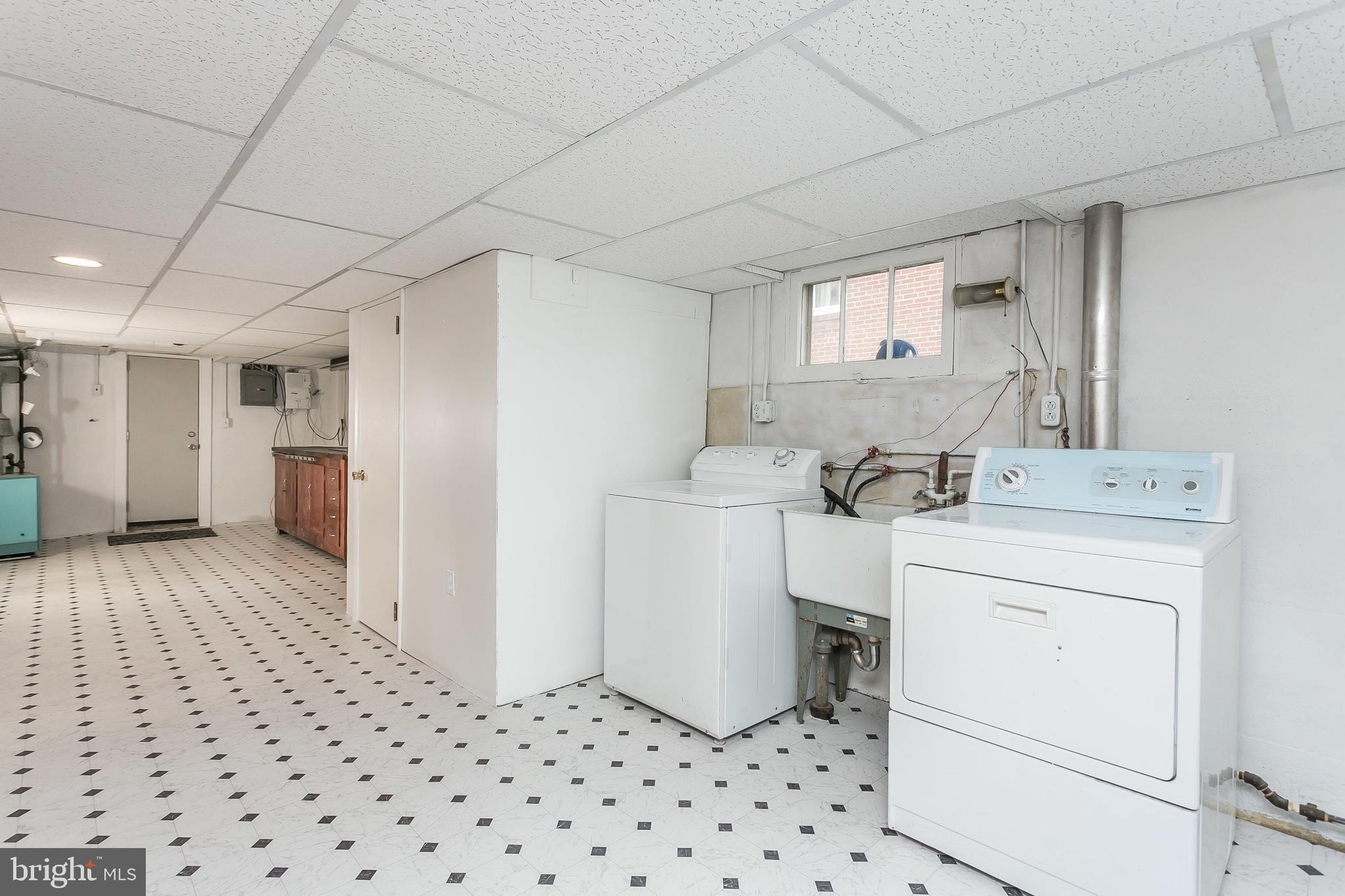 3115 Willoughby Road Baltimore, MD 21234 - Photo 29 of 37 Laundry, half bath, work bench, and exterior door