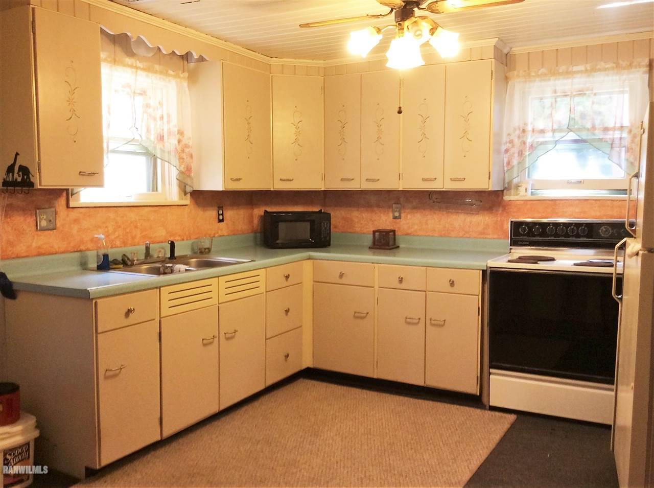 328 Franklin Street Galena, IL 61036 - Photo 2 of 13 a kitchen with a sink dishwasher stove and white cabinets