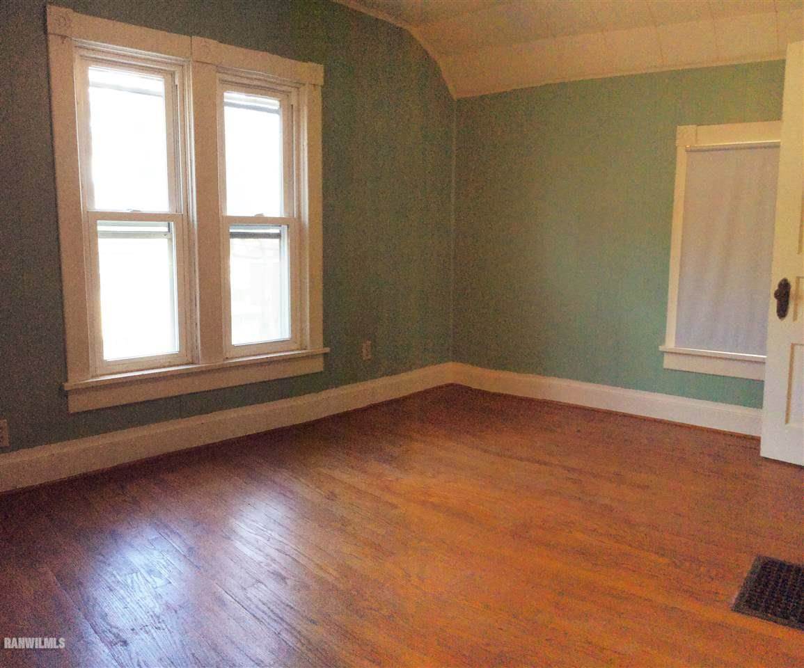 328 Franklin Street Galena, IL 61036 - Photo 5 of 13 an empty room with wooden floor and windows