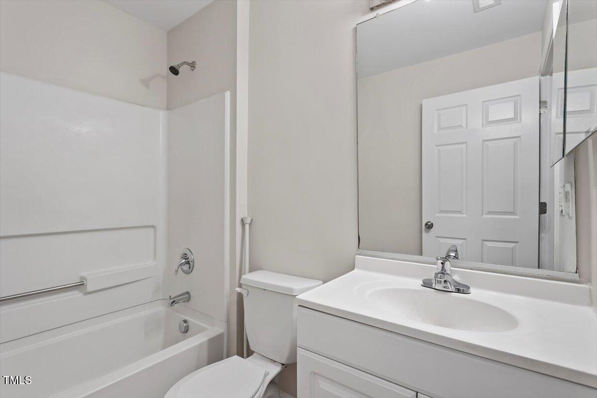 8600 Neuse Landing Lane, Unit 106 Raleigh, NC 27616 - Photo 12 of 22 a bathroom with a sink a toilet and a bathtub