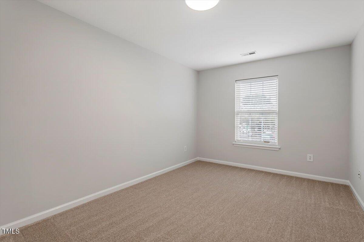 8600 Neuse Landing Lane, Unit 106 Raleigh, NC 27616 - Photo 13 of 22 an empty room with a window