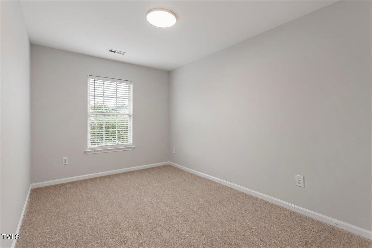8600 Neuse Landing Lane, Unit 106 Raleigh, NC 27616 - Photo 15 of 22 an empty room with a window