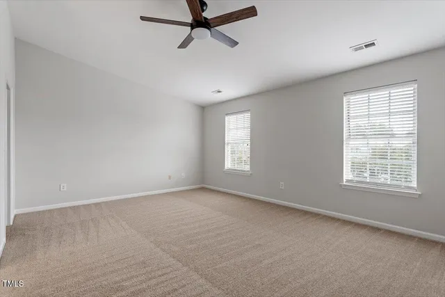 a view of a livingroom with a ceiling fan and window