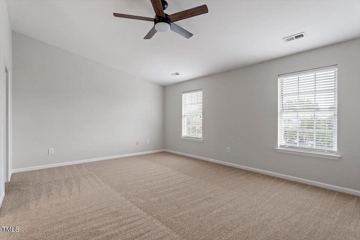 8600 Neuse Landing Lane, Unit 106 Raleigh, NC 27616 - Photo 17 of 22 a view of a livingroom with a ceiling fan and window