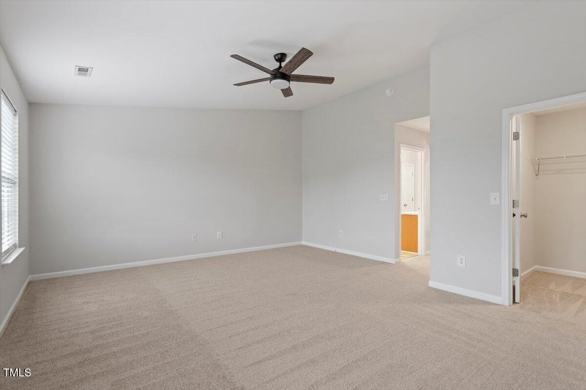 8600 Neuse Landing Lane, Unit 106 Raleigh, NC 27616 - Photo 19 of 22 an empty room with closet and windows