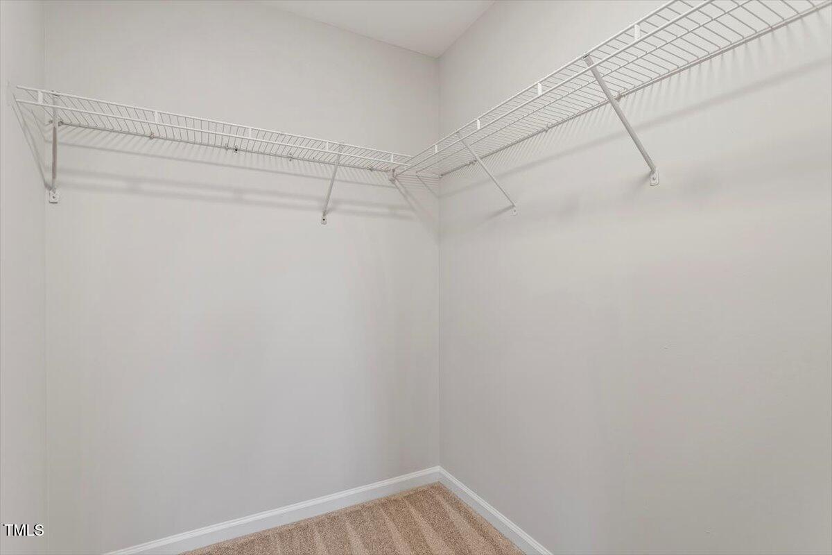 8600 Neuse Landing Lane, Unit 106 Raleigh, NC 27616 - Photo 20 of 22 a view of a room with racks on the wall