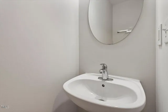 a bathroom with a sink and mirror