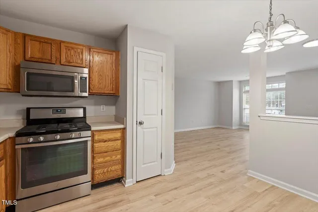 a kitchen with granite countertop wooden cabinets and stainless steel appliances