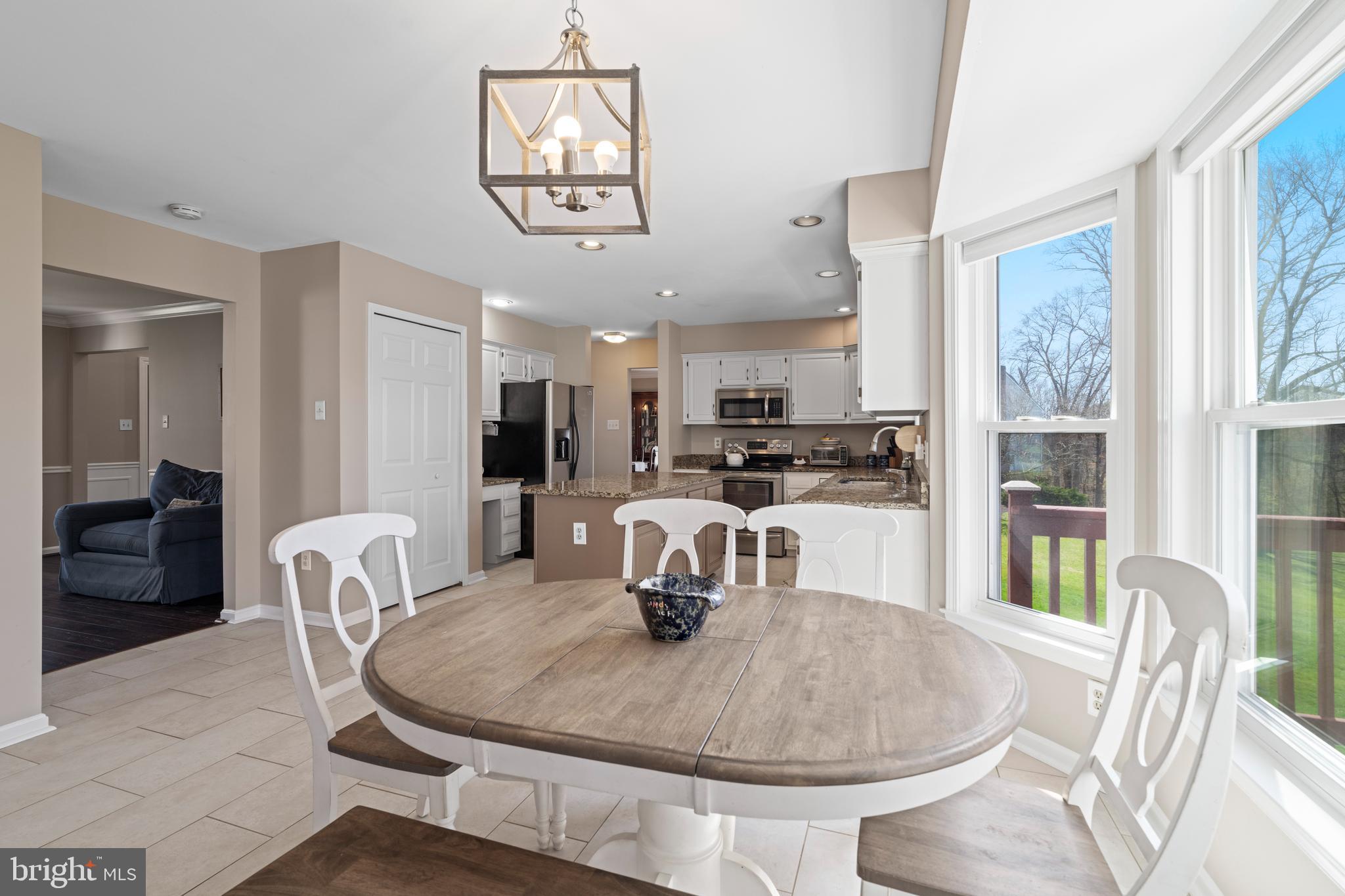 20 Farm Ridge Court Baldwin, MD 21013 - Photo 12 of 47 a kitchen with granite countertop a table and chairs