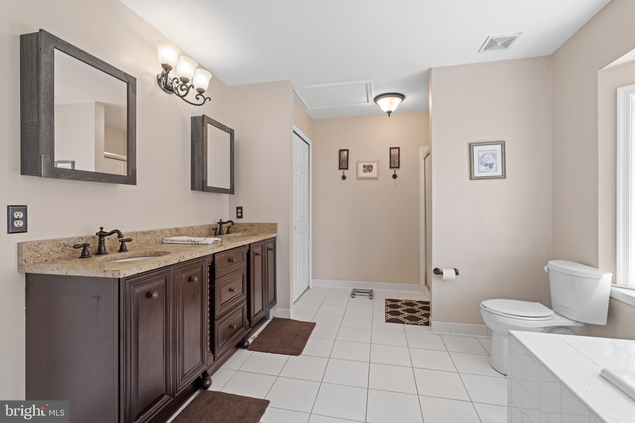 20 Farm Ridge Court Baldwin, MD 21013 - Photo 20 of 47 a spacious bathroom with a double vanity sink a mirror and a