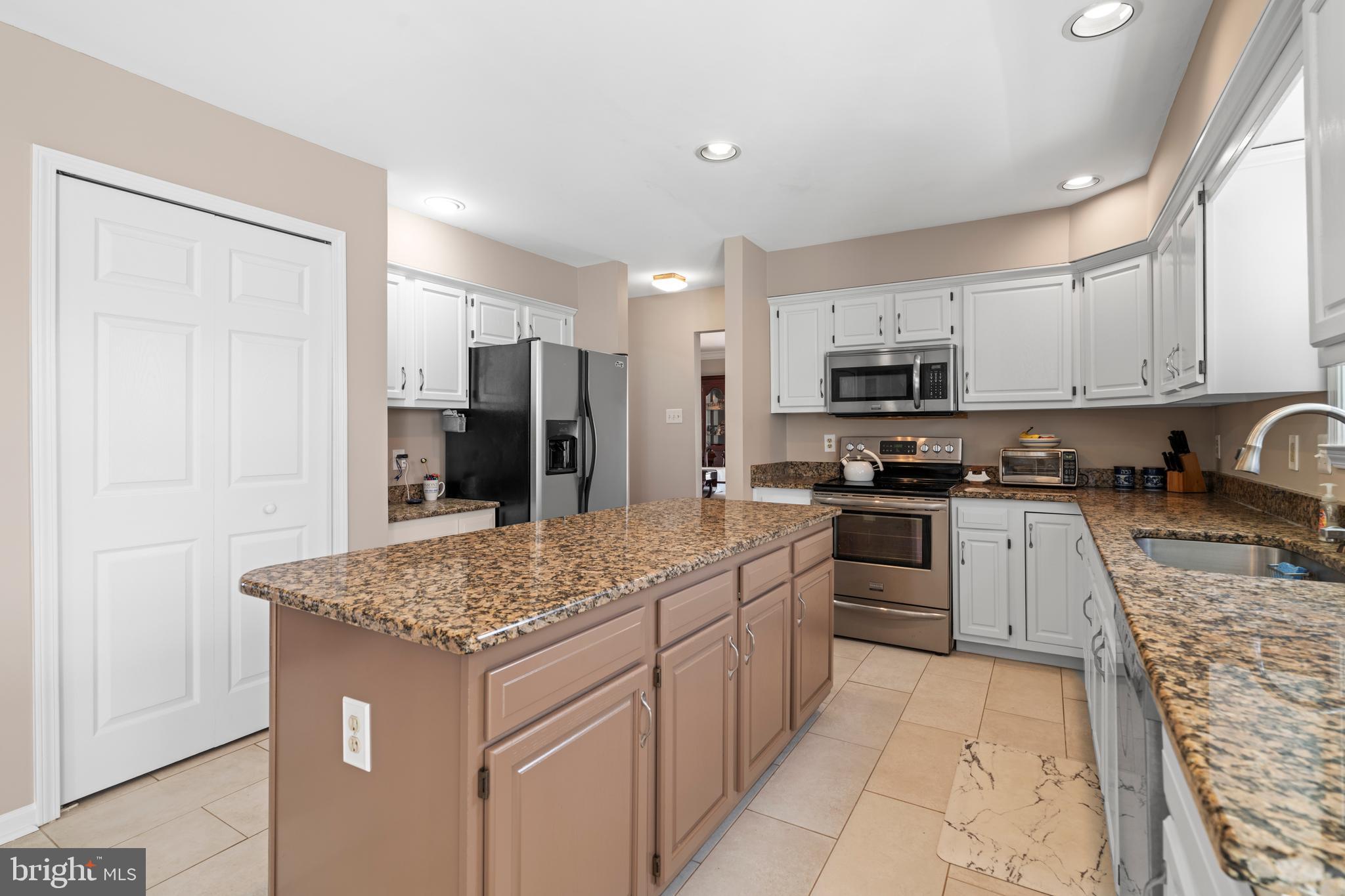 20 Farm Ridge Court Baldwin, MD 21013 - Photo 9 of 47 a kitchen with stainless steel appliances granite countertop a sink stove and refrigerator