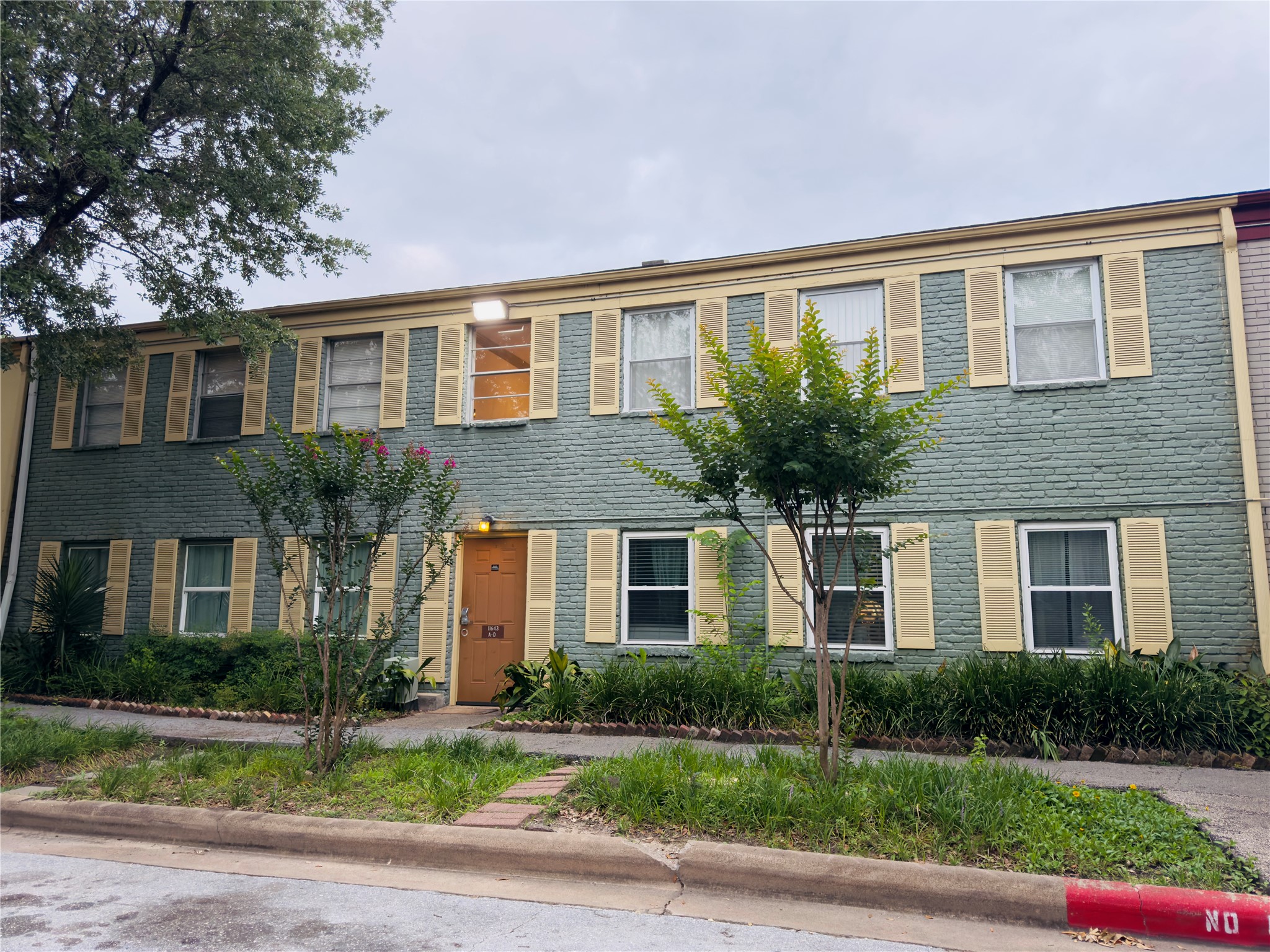 11643 Chimney Rock Road, Unit B Houston, TX 77035 - Photo 2 of 9 a front view of a house with a yard and a garage
