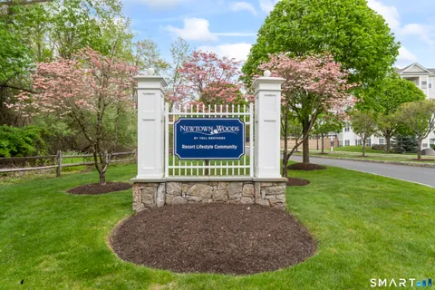 a sign that is sitting on the grass of the house