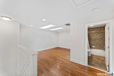 a view of hallway with wooden floor