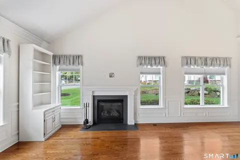 a view of a livingroom with a fireplace and window