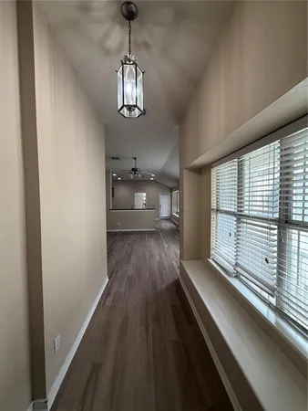 a view of a room with wooden floor cabinets and windows