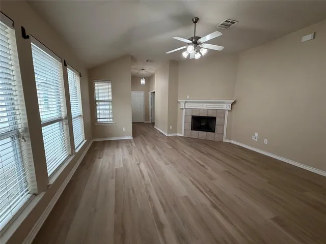 wooden floor fireplace and natural light in room