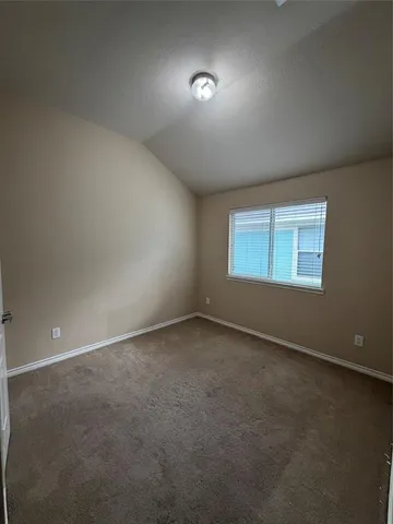 an empty room with a empty space and windows