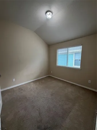 an empty room with a empty space and windows