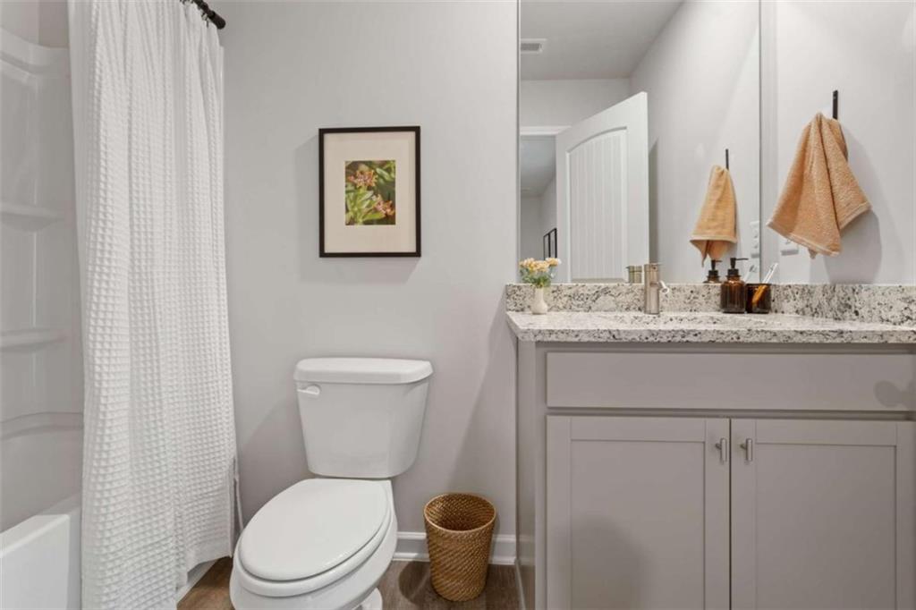 116 Meadowview Drive, Unit 8 Temple, GA 30179 - Photo 15 of 26 a bathroom with a toilet sink and mirror