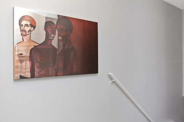 a view of room with wooden floor and fan